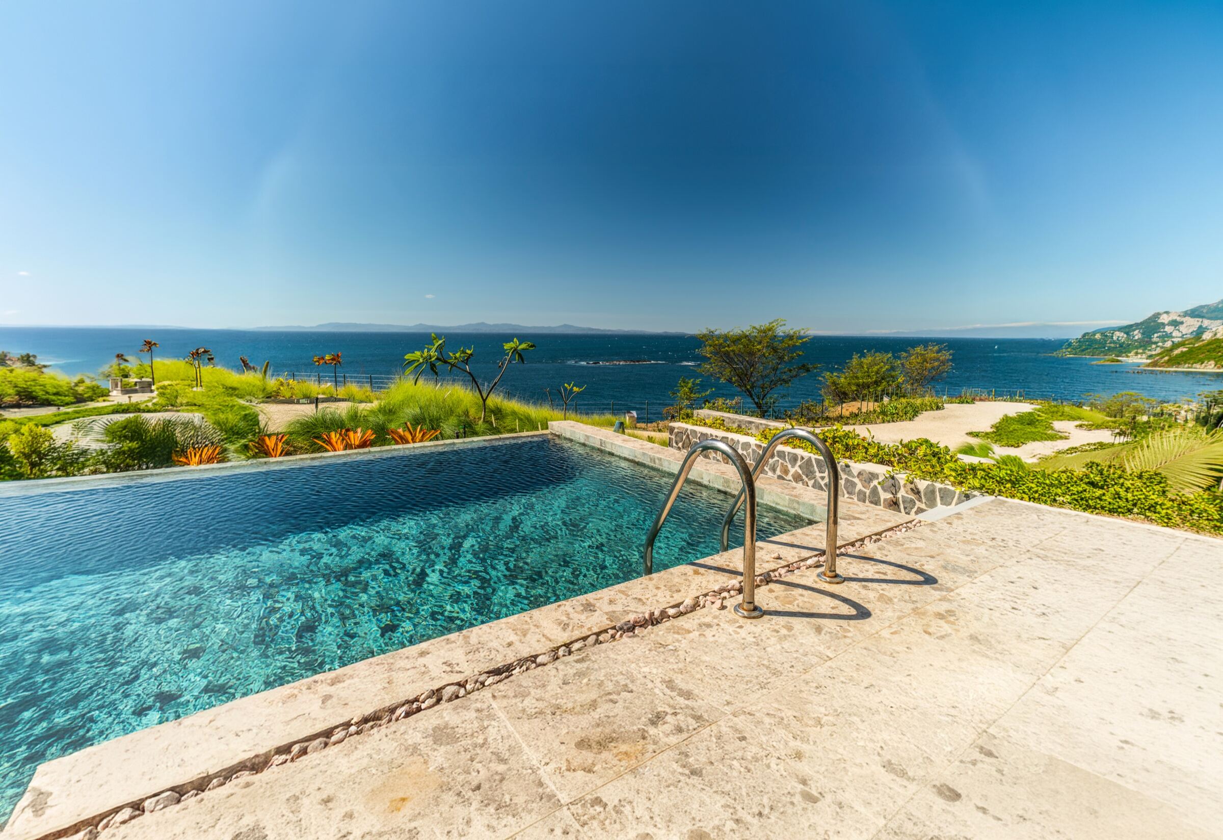 Infinity pool overlooking the Pacific Ocean at a Zen Reserve residence